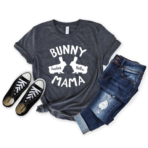 May include: A dark heather grey t-shirt with the text "Bunny Mama" and two white bunny silhouettes with the names "Amber" and "Bella" printed on them.